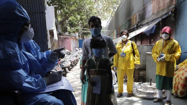 Residents of a slum interact with medical officers during lockdown to control the spread of the new coronavirus in Mumbai, India. (AP) Residents of a slum interact with medical officers during lockdown to control the spread of the new coronavirus in Mumbai, India. (AP)