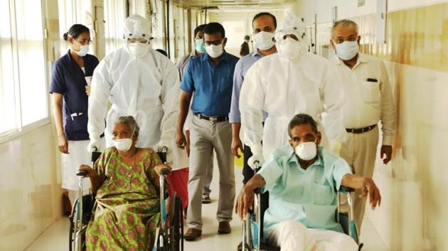 The grandparents of Rijo Moncy, who had tested positive for Covid-19 disease, after their release from the Kottayam hospital earlier this month.(HT Photo)