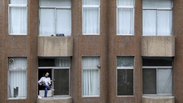 Musician Ali Haddadian, 42, plays the tar, a long-necked string instrument, from his window, in Tehran. Impromptu concerts break the monotony of isolation and offer hope to listeners. (Ebrahim Noroozi / AP) Musician Ali Haddadian, 42, plays the tar, a long-necked string instrument, from his window, in Tehran. Impromptu concerts break the monotony of isolation and offer hope to listeners. (Ebrahim Noroozi / AP)