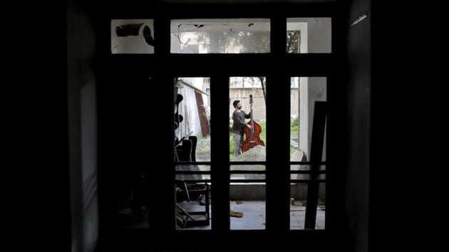 Musician Arif Mirbaghi, 33, plays the double bass in the yard of his house in Tehran to an audience he can’t immediately see, but is connected to by his music. (Ebrahim Noroozi / AP) Musician Arif Mirbaghi, 33, plays the double bass in the yard of his house in Tehran to an audience he can’t immediately see, but is connected to by his music. (Ebrahim Noroozi / AP)