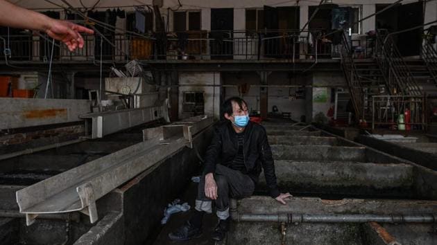 Workers at Baishazhou said they were now required to disinfect their stalls several times a day. Yang keeps multiple bottles of disinfectant in her small office, alongside a box of masks, AFP reported. (Hector RETAMAL / AFP) 