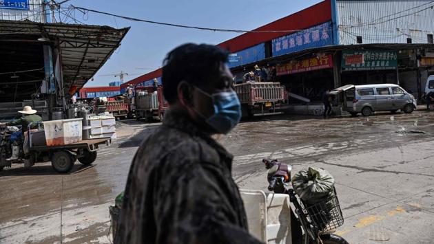 Low foot traffic at the market, which has locked all but one entrance and only allows customers in after a temperature check, remains their main concern. (Hector RETAMAL / AFP) 