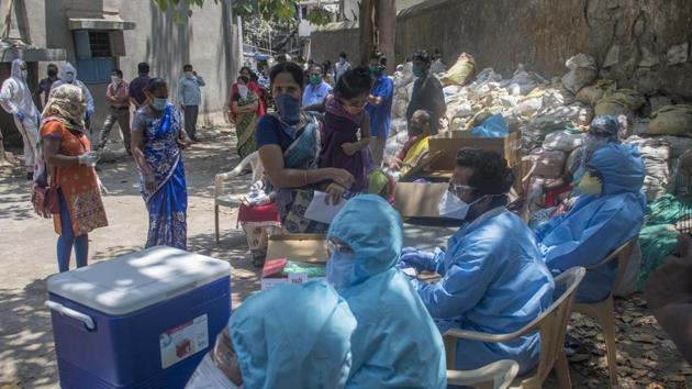 Doctors and municipal staff attend to people of Dharavi in Mumbai at a Covid-19 testing drive, on Thursday.(Pratik Chorge/HT Photo) Doctors and municipal staff attend to people of Dharavi in Mumbai at a Covid-19 testing drive, on Thursday.(Pratik Chorge/HT Photo)