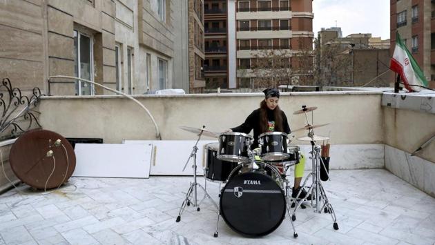 Farideh Sarsangi, 28, plays drums on the roof of her home in Tehran. With its own rich history dating back thousands of years, music has been a mainstay of public life. Western influences and sounds disappeared after the Iranian Revolution but re-emerged in recent decades. There still remain cultural limits on concerts and women performers. (Ebrahim Noroozi / AP) Farideh Sarsangi, 28, plays drums on the roof of her home in Tehran. With its own rich history dating back thousands of years, music has been a mainstay of public life. Western influences and sounds disappeared after the Iranian Revolution but re-emerged in recent decades. There still remain cultural limits on concerts and women performers. (Ebrahim Noroozi / AP)