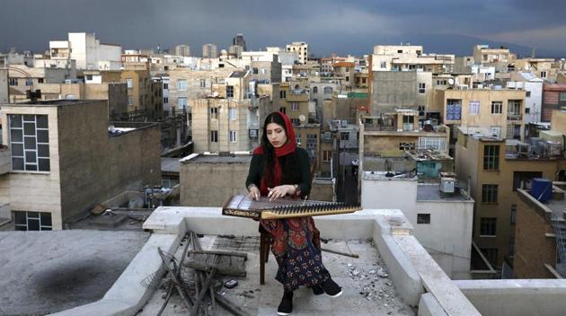 Mojgan Hosseini, 28, a member of the National Orchestra of Iran, plucks away at a Qanun on the roof of her home during mandatory self-isolation, in Tehran. With almost 78,000 cases of coronavirus and over 4,800 deaths to the COVID019 disease caused by the virus, Iran faces the worst of the virus outbreak in the Middle East. (Ebrahim Noroozi / AP) Mojgan Hosseini, 28, a member of the National Orchestra of Iran, plucks away at a Qanun on the roof of her home during mandatory self-isolation, in Tehran. With almost 78,000 cases of coronavirus and over 4,800 deaths to the COVID019 disease caused by the virus, Iran faces the worst of the virus outbreak in the Middle East. (Ebrahim Noroozi / AP)