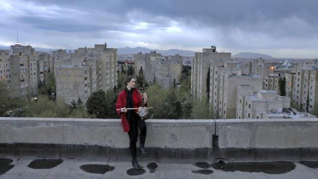 Shiva Abedi, 30, plays the Kamancheh on the roof of her home in Tehran. The rooftop terrace has turned into a stage, and the music here can be heard alongside the chirping of birds, or the odd car passing by. (Ebrahim Noroozi / AP) Shiva Abedi, 30, plays the Kamancheh on the roof of her home in Tehran. The rooftop terrace has turned into a stage, and the music here can be heard alongside the chirping of birds, or the odd car passing by. (Ebrahim Noroozi / AP)