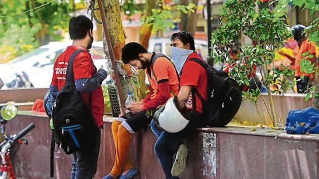 Delivery persons wait to pick up orders from restaurants in Delhi’s Malviya Nagar. A delivery agent with an eatery in the area has tested positive for the coronavirus disease. (Amal KS/HT FILE) Delivery persons wait to pick up orders from restaurants in Delhi’s Malviya Nagar. A delivery agent with an eatery in the area has tested positive for the coronavirus disease. (Amal KS/HT FILE)