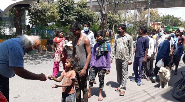 Noida based social activist Anoop Khanna distributing dry ration among needy and underprivileged at an otherwise deserted street of the city Noida based social activist Anoop Khanna distributing dry ration among needy and underprivileged at an otherwise deserted street of the city
