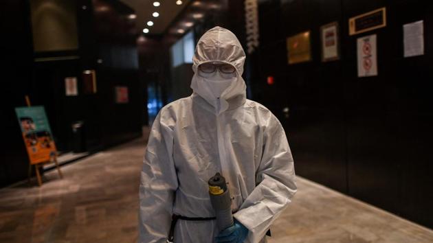 A hotel worker disinfects the dining room of a hotel in Wuhan, China's central Hubei province on April 16, 2020.(AFP photo)