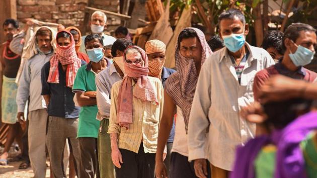 People in a queue at a food distribution by NGO workers during the lockdown against coronavirus, at Kirti Nagar Furniture Market in New Delhi, India, on Friday, April 17, 2020. (Sanchit Khanna/HT PHOTO) People in a queue at a food distribution by NGO workers during the lockdown against coronavirus, at Kirti Nagar Furniture Market in New Delhi, India, on Friday, April 17, 2020. (Sanchit Khanna/HT PHOTO)