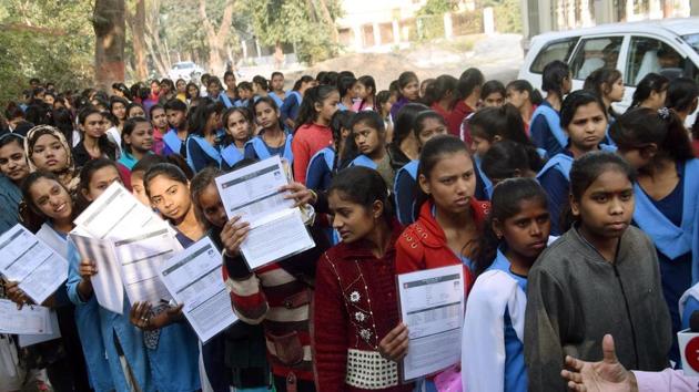 Examinee students are standing in long queue for entering in the examination centre at Bankipur Girls High School in Patna during first day of 10th class exam of Bihar School Examination Board (BSEB) Examinee students are standing in long queue for entering in the examination centre at Bankipur Girls High School in Patna during first day of 10th class exam of Bihar School Examination Board (BSEB)