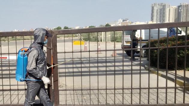 A BPTP Park Serene staff member sanitize the complex during Covid-19 lockdown, in Gurugram, Haryana. (Yogendra Kumar/HT PHOTO) A BPTP Park Serene staff member sanitize the complex during Covid-19 lockdown, in Gurugram, Haryana. (Yogendra Kumar/HT PHOTO)