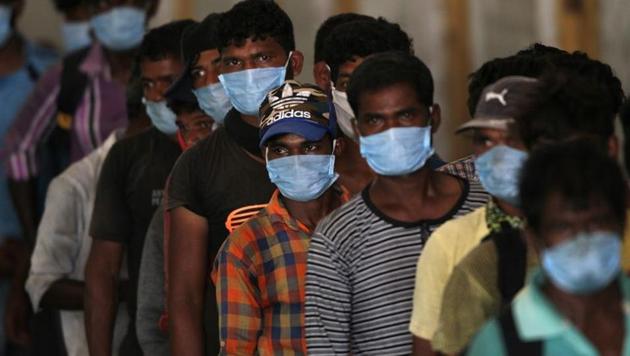 Fishermen wait to get their health checkup after they disembarked from their boats after travelling in the Arabian Sea to reach to their home state Maharashtra from the western state of Gujarat. (Reuters Photo) Fishermen wait to get their health checkup after they disembarked from their boats after travelling in the Arabian Sea to reach to their home state Maharashtra from the western state of Gujarat. (Reuters Photo)