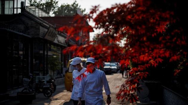 Kitchen staff walk in the deserted Wudaoying Hutong, one of the top tourist destinations in Beijing, as the spread of the novel coronavirus disease (COVID-19) continues in China.(REUTERS) Kitchen staff walk in the deserted Wudaoying Hutong, one of the top tourist destinations in Beijing, as the spread of the novel coronavirus disease (COVID-19) continues in China.(REUTERS)