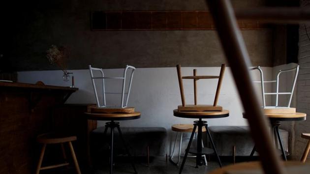 Stools are turned upside down in a cafe that is closed for regular business but open for takeout in the Wudaoying Hutong.(Reuters photo)