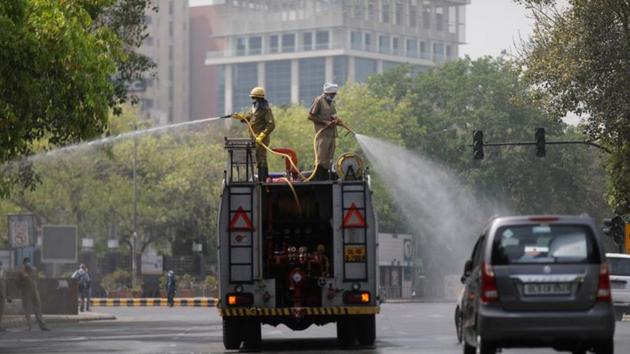 Municipal workers spray disinfectant at a market area during an extended nationwide lockdown to slow the spread of the coronavirus disease (COVID-19) in New Delhi.(Reuters/ Representative image)