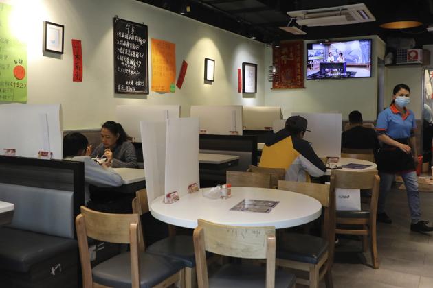 Customers have breakfast with plastic panels setup on the tables to protect themselves from possibly contracting the coronavirus COVID-19 at a restaurant in Hong Kong, Saturday, April 18, 2020. (AP Photo/Kin Cheung) (AP) Customers have breakfast with plastic panels setup on the tables to protect themselves from possibly contracting the coronavirus COVID-19 at a restaurant in Hong Kong, Saturday, April 18, 2020. (AP Photo/Kin Cheung) (AP)