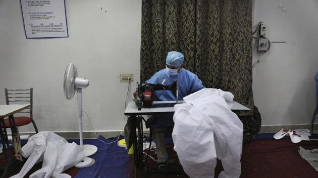 A Central Reserve Police Force soldier stitches a Personal Protective Equipment (PPE) suit for health workers combating the spread of the new coronavirus in New Delhi. (AP) A Central Reserve Police Force soldier stitches a Personal Protective Equipment (PPE) suit for health workers combating the spread of the new coronavirus in New Delhi. (AP)