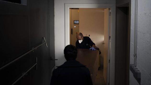Workers carry a coffin ahead of cremation at the Memora Manresa funeral home in Manresa, Barcelona province. Although authorities in Spain believe they have passed the peak of the contagion curve and began relaxing lockdown measures this week, there are still more bodies coming into the Barcelona garage morgue than are leaving. (Felipe Dana / AP) Workers carry a coffin ahead of cremation at the Memora Manresa funeral home in Manresa, Barcelona province. Although authorities in Spain believe they have passed the peak of the contagion curve and began relaxing lockdown measures this week, there are still more bodies coming into the Barcelona garage morgue than are leaving. (Felipe Dana / AP)