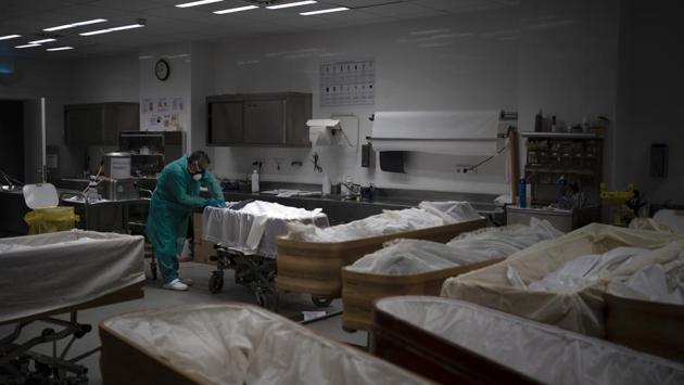 A mortician prepares the body at the Sancho de Avila Funeral Home. Fernandez said some of his colleagues were being asked to open coffins so anxious relatives could confirm it was indeed their loved ones inside — a request they had to refuse. “It shatters our soul when we have to tell them, ‘No, we can’t,’” Fernandez said. (Felipe Dana / AP) A mortician prepares the body at the Sancho de Avila Funeral Home. Fernandez said some of his colleagues were being asked to open coffins so anxious relatives could confirm it was indeed their loved ones inside — a request they had to refuse. “It shatters our soul when we have to tell them, ‘No, we can’t,’” Fernandez said. (Felipe Dana / AP)