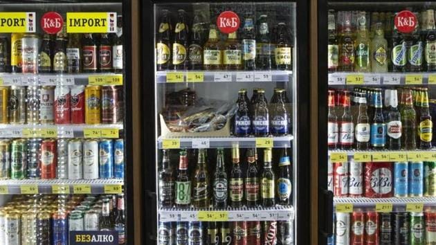 Beers and other alcoholic drinks sit on display in a refrigerator.(Bloomberg)