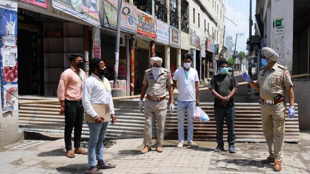Punjab Police stand vigil at a sealed street after a PGI worker and family members tested positive at Adarsh nagar in Nayagaon, Mohali, on Sunday. (Anil Dayal/Hindustan Times) Punjab Police stand vigil at a sealed street after a PGI worker and family members tested positive at Adarsh nagar in Nayagaon, Mohali, on Sunday. (Anil Dayal/Hindustan Times)
