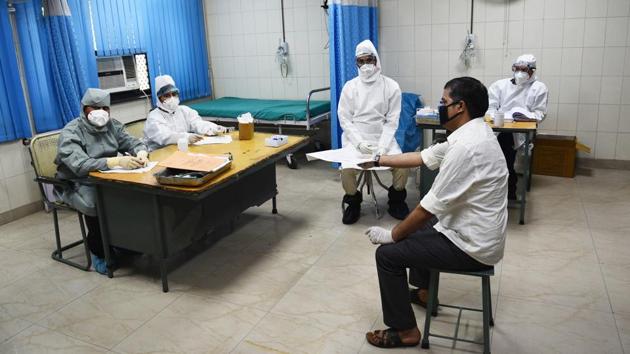 Doctors wearing Personal Protective Equipment (PPE) during a consultation at a special Flu Centre in the Aruna Asaf Ali Hospital at Rajpur Road in New Delhi, India, on Saturday, April 18, 2020. (Vipin Kumar/HT PHOTO) Doctors wearing Personal Protective Equipment (PPE) during a consultation at a special Flu Centre in the Aruna Asaf Ali Hospital at Rajpur Road in New Delhi, India, on Saturday, April 18, 2020. (Vipin Kumar/HT PHOTO)