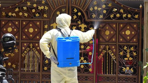 An East Delhi Municipal Corporation (EMCD) worker sprays disinfectant while sanitizing the Swasthya Vihar area during lockdown to check the spread of coronavirus in New Delhi on Saturday. (Raj K Raj/HT PHOTO) An East Delhi Municipal Corporation (EMCD) worker sprays disinfectant while sanitizing the Swasthya Vihar area during lockdown to check the spread of coronavirus in New Delhi on Saturday. (Raj K Raj/HT PHOTO)