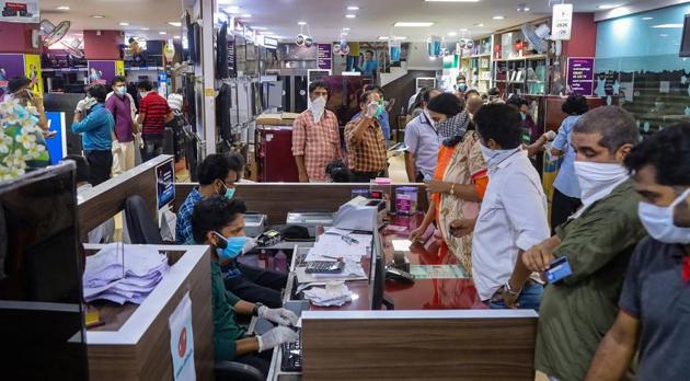 Shoppers in an electronic goods showroom in Kozhikodein Kerala that now opens once a week.(PTI)