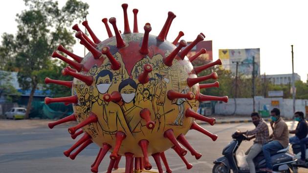 Men wearing protective masks ride scooters past a coronavirus-themed globe installed alongside a road to create awareness about staying at home during an extended nationwide lockdown to slow the spreading of the coronavirus disease in Hyderabad, on April 19. (Reuters Photo) Men wearing protective masks ride scooters past a coronavirus-themed globe installed alongside a road to create awareness about staying at home during an extended nationwide lockdown to slow the spreading of the coronavirus disease in Hyderabad, on April 19. (Reuters Photo)