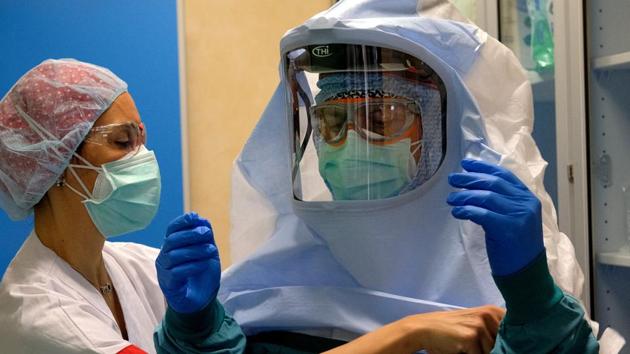 A nurse helps a colleague to dress up to enter the intensive care unit of the COVID-19 department of the Policlinic of Tor Vergata in Rome. (AP) A nurse helps a colleague to dress up to enter the intensive care unit of the COVID-19 department of the Policlinic of Tor Vergata in Rome. (AP)