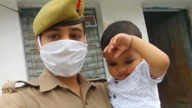 Police officer Chitralekha on duty with her one-year-old child.