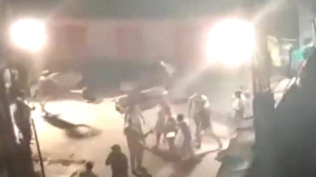 The locals in Padarayanapura seen breaking barricades on Sunday night. (Video grab/ANI) The locals in Padarayanapura seen breaking barricades on Sunday night. (Video grab/ANI)