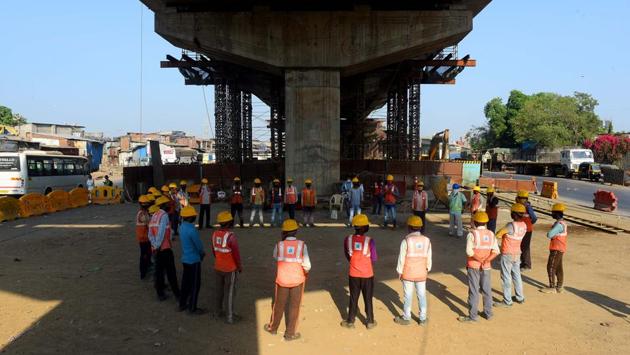 A huddle before work at the Deonar flyover site in Mumbai. Maharashtra, which has the highest number of Covid-19 cases for any state, allowed industries to resume work in 20 of its 36 districts, which either don’t have any COVID-19 cases or have very few. Industries in rural areas as well as certain public works in Mumbai have also been allowed. (Vijayanand Gupta / HT Photo) A huddle before work at the Deonar flyover site in Mumbai. Maharashtra, which has the highest number of Covid-19 cases for any state, allowed industries to resume work in 20 of its 36 districts, which either don’t have any COVID-19 cases or have very few. Industries in rural areas as well as certain public works in Mumbai have also been allowed. (Vijayanand Gupta / HT Photo)