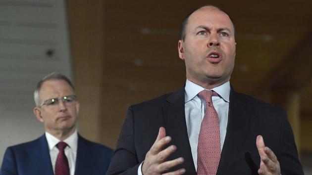 Australia's treasurer Josh Frydenberg, right, with minister for communications Paul Fletcher speaks in Canberra, Monday, April 20. Global digital platforms Google and Facebook will be forced to pay for news content in Australia, the government said on Monday as the coronavirus pandemic causes a collapse in advertising revenue (AP) Australia's treasurer Josh Frydenberg, right, with minister for communications Paul Fletcher speaks in Canberra, Monday, April 20. Global digital platforms Google and Facebook will be forced to pay for news content in Australia, the government said on Monday as the coronavirus pandemic causes a collapse in advertising revenue (AP)