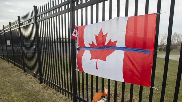 A tribute is displayed Monday, April 20, 2020, at the Royal Canadian Mounted Police headquarters in Dartmouth, Nova Scotia, following a weekend shooting rampage by a gunman, disguised as a police officer, that killed multiple people including an RCMP constable. (AP) A tribute is displayed Monday, April 20, 2020, at the Royal Canadian Mounted Police headquarters in Dartmouth, Nova Scotia, following a weekend shooting rampage by a gunman, disguised as a police officer, that killed multiple people including an RCMP constable. (AP)