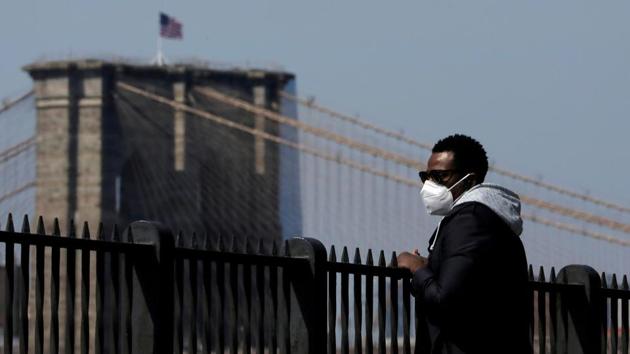 A man wearing a face mask looks toward Brooklyn Bridge during the outbreak of the coronavirus disease Covid-19 in Brooklyn, New York City, on April 19.(Reuters Photo) A man wearing a face mask looks toward Brooklyn Bridge during the outbreak of the coronavirus disease Covid-19 in Brooklyn, New York City, on April 19.(Reuters Photo)