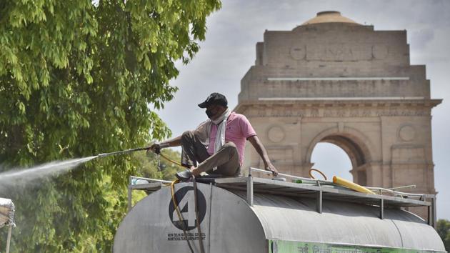 A worker of the Horticulture department sprays disinfectant from a tanker during lockdown, at India Gate, in New Delhi, India, on Monday, April 20, 2020. (Burhaan Kinu/HT PHOTO) A worker of the Horticulture department sprays disinfectant from a tanker during lockdown, at India Gate, in New Delhi, India, on Monday, April 20, 2020. (Burhaan Kinu/HT PHOTO)