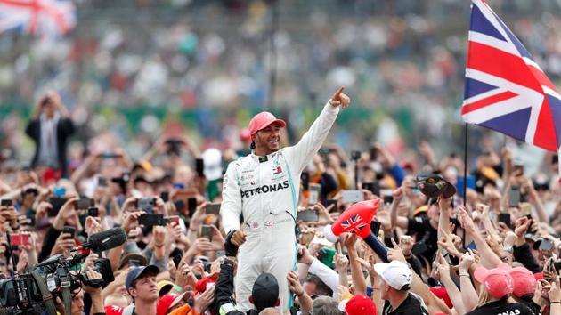 Mercedes' Lewis Hamilton celebrates with the crowd after winning the race.(REUTERS)
