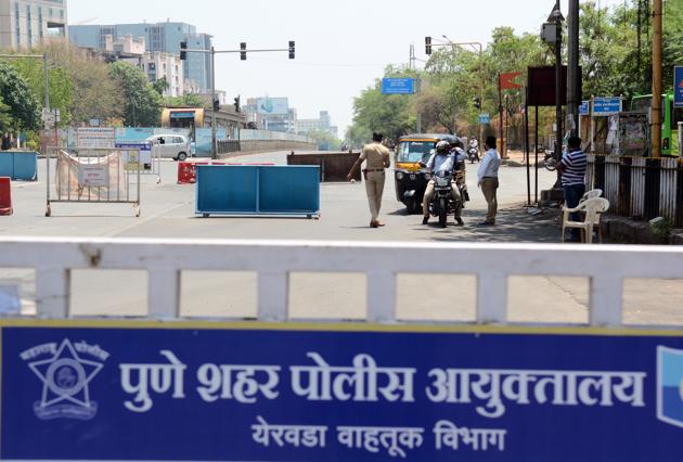 Police personnel checks the curfew passes of motorists at Wadgaonsheri, Novotel chowk, in Pune on Monday. (SHANKAR NARAYAN/HT) Police personnel checks the curfew passes of motorists at Wadgaonsheri, Novotel chowk, in Pune on Monday. (SHANKAR NARAYAN/HT)