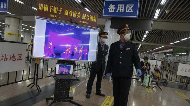 Train station staff oversee a thermal imaging check point for passengers from Wuhan after they arrive on a high speed train in Beijing on Sunday. (AP) Train station staff oversee a thermal imaging check point for passengers from Wuhan after they arrive on a high speed train in Beijing on Sunday. (AP)