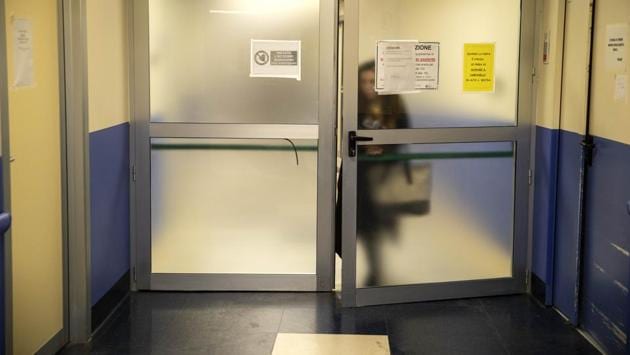 Nurse Cristina Settembrese leaves the COVID-19 ward of San Paolo hospital in Milan. The coronavirus brings with it forced isolation of several sorts -- family members can’t visit hospitalised patients, nursing homes bar outsiders and people with mild cases or who have been in contact with infected persons must stay in quarantine. (Luca Bruno / AP) Nurse Cristina Settembrese leaves the COVID-19 ward of San Paolo hospital in Milan. The coronavirus brings with it forced isolation of several sorts -- family members can’t visit hospitalised patients, nursing homes bar outsiders and people with mild cases or who have been in contact with infected persons must stay in quarantine. (Luca Bruno / AP)