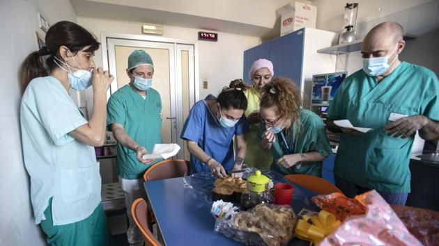 Settembrese shares food and Easter eggs with colleagues at the hospital. Walking Pepe and chatting with fellow dog owners at a safe distance “is my only social life,” Settembrese told the AP. But Settembrese speaks of her new family — her patients and colleagues — with whom she has forged bonds in these past fraught weeks. (Luca Bruno / AP) Settembrese shares food and Easter eggs with colleagues at the hospital. Walking Pepe and chatting with fellow dog owners at a safe distance “is my only social life,” Settembrese told the AP. But Settembrese speaks of her new family — her patients and colleagues — with whom she has forged bonds in these past fraught weeks. (Luca Bruno / AP)