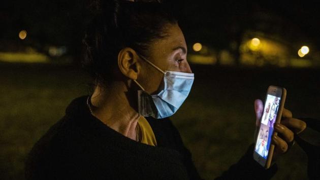Settembrese makes a video call to say goodnight to her parents near her home, after her work shift ends. (Luca Bruno / AP) Settembrese makes a video call to say goodnight to her parents near her home, after her work shift ends. (Luca Bruno / AP)