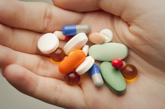 Pills on a person's palm Pills on a person's palm