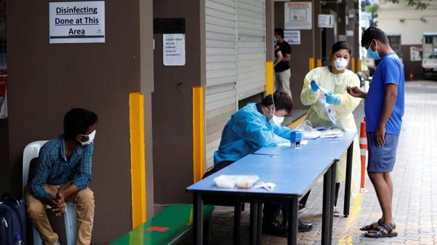 Medical screening takes place at Westlite Toh Guan dormitory. Low-wage migrant workers, a vital part of Singapore’s workforce, now account for at least 60% of its infections. (Ministry of Manpower Singapore via REUTERS) Medical screening takes place at Westlite Toh Guan dormitory. Low-wage migrant workers, a vital part of Singapore’s workforce, now account for at least 60% of its infections. (Ministry of Manpower Singapore via REUTERS)