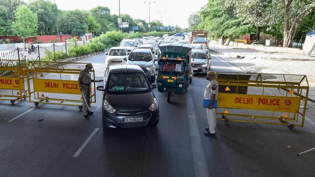 Security personnel check vehicles near ISBT during the relaxation in nationwide lockdown, in New Delhi on Monday.(PTI Photo)