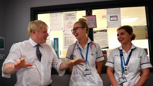 In this file photo taken on November 08, 2019 Britain's Prime Minister Boris Johnson (L) gestures as he talks with physiotherapist (C) and on occupational therapist as he meets nursing staff during a general election campaign visit to King's Mill NHS Hospital in Mansfield, northern England, on November 8, 2019. (AFP) In this file photo taken on November 08, 2019 Britain's Prime Minister Boris Johnson (L) gestures as he talks with physiotherapist (C) and on occupational therapist as he meets nursing staff during a general election campaign visit to King's Mill NHS Hospital in Mansfield, northern England, on November 8, 2019. (AFP)