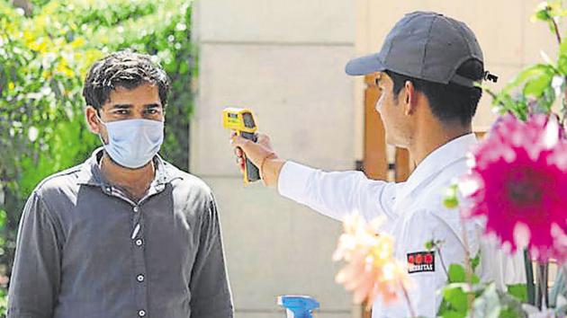 At the gate, security guards have been provided with infrared thermometers to measure the temperature of those entering the society. (Yogendra Kumar/HT file photo. Representative image) At the gate, security guards have been provided with infrared thermometers to measure the temperature of those entering the society. (Yogendra Kumar/HT file photo. Representative image)