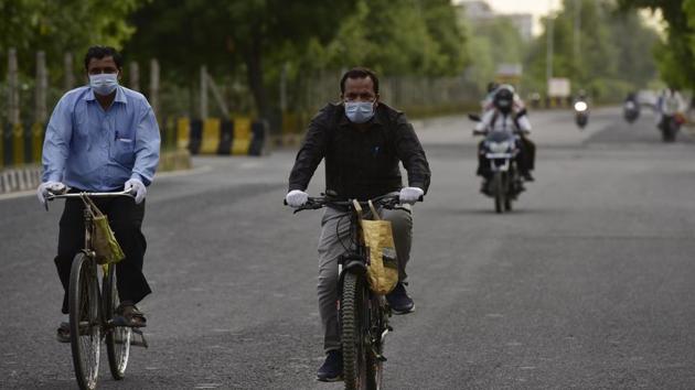 Cyclists wear face mask during a government-imposed nationwide lockdown against the spread of coronavirus in Noida.(Virendra Singh Gosain/HT PHOTO)